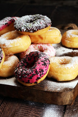 assorted donuts with chocolate frosted, pink glazed and sprinkle