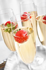 Glasses of delicious wine with strawberry on table © Africa Studio