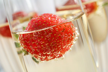 Glass of delicious wine with strawberry, closeup