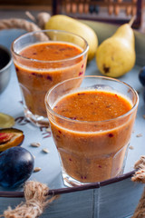 Smoothies with plum, pear, sunflower seeds and honey, selective focus