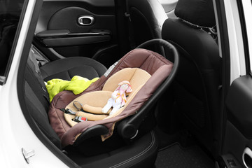 Child safety seat with cute toy in car