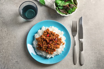 Chili con carne served with rice on dinner table