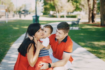 beautiful family in red walking down the street and the Park