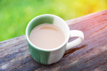 cup of coffee in morning on wooden table.
