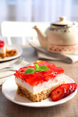 Plate with delicious strawberry pretzel salad on table
