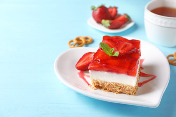 Plate with delicious strawberry pretzel salad on table