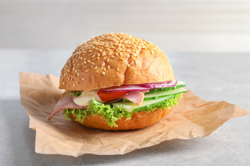 Tasty sandwich with fresh cucumber on table