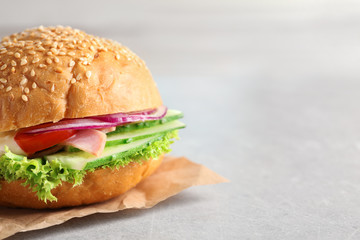Tasty sandwich with fresh cucumber on table