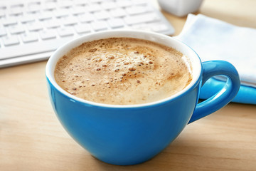 Cup of aromatic morning coffee on table