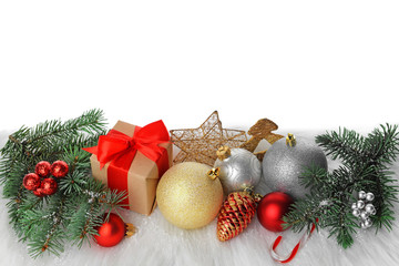 Beautiful composition with Christmas decorations and brunches of fir tree on soft plaid