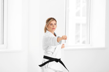 Female karate instructor training in dojo © Africa Studio