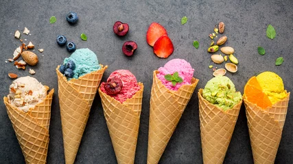 Wall murals Best sellers in the kitchen Various of ice cream flavor in cones blueberry ,strawberry ,pistachio ,almond ,orange and cherry setup on dark stone background . Summer and Sweet menu concept.