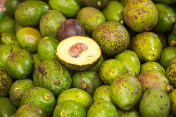 pile of avocadoes in the market