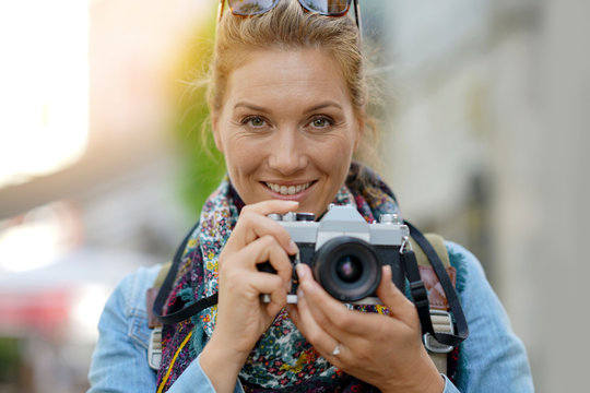 Cheerful woman taking picture on vacation day