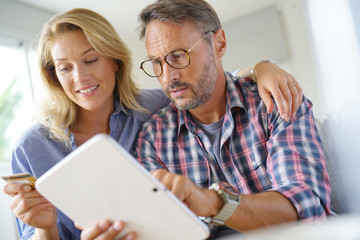 Mature couple buying on internet, online shopping