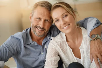 Foto op Canvas Mature couple relaxing at home, looking at camera © goodluz