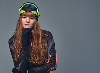 Redhead female Biathlon champion aiming with a competitive gun.