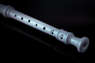 classical musical instrument is the block flute on black background © YB