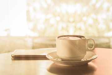 Obraz na płótnie Canvas Cup of hot coffee on wood table