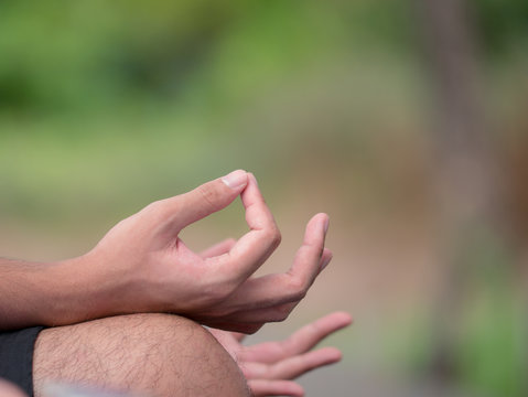 The hand of young man doing meditation in Yoga practice.