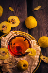 Tincture cup fruit quince wooden table