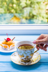 Still life with cup of tea on the wooden background