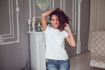 Curly haired girl with freckles in blank white t-shirt. Mock up.