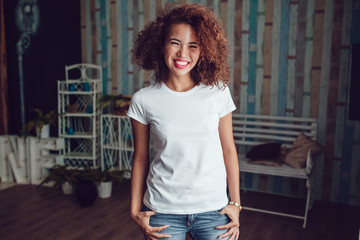 Curly haired girl with freckles in blank white t-shirt. Mock up.