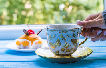 Still life with cup of tea on the wooden background