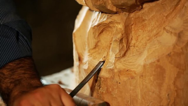working with wooden statue and carving wood