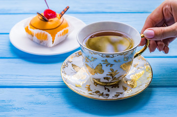 Still life with cup of tea on the wooden background