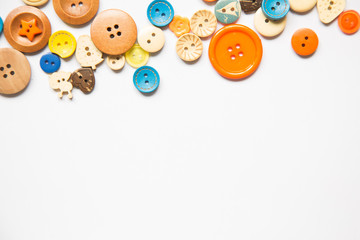 Beautiful colorful buttons on a white background. Beautiful handcraft composition. A button on a...