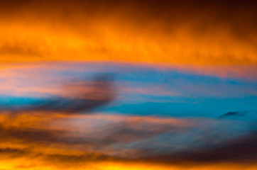 Fototapeta na wymiar Background texture of dramatic sunset sky with orange clouds after thunderstorm