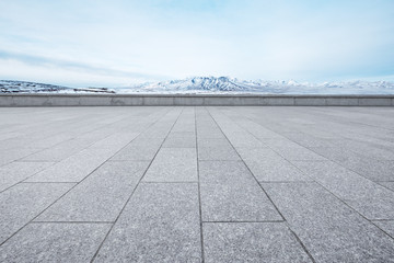 empty marble floor with beautiful snow mountains
