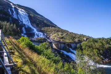 Summer mountain Langfossen waterfall on slope (Etne, Norway).