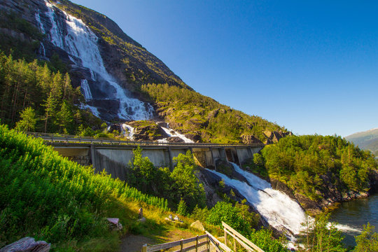 Summer mountain Langfossen waterfall on slope (Etne, Norway).