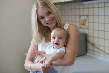 blonde mom with baby in her arms,  real interior