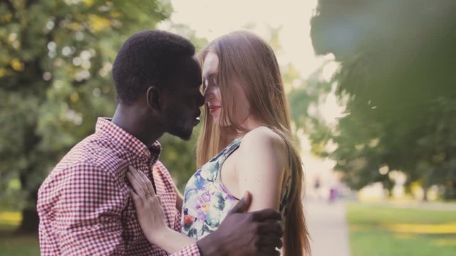 happy interracial couple in city park