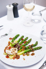 Grilled green asparagus and poached egg with balsamic dressing