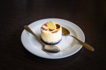 Fresh Japanese Cheesecake on white plate on wooden table background