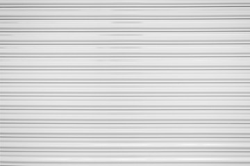 The texture of corrugated metal sheet, white or gray galvanizes steel rolling shutter.