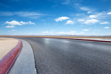 Fototapeta na wymiar empty asphalt road with snow mountains