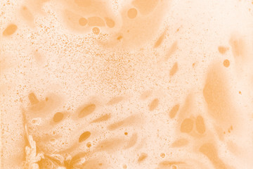 Liquid honey with foam background, texture, close up. Macro