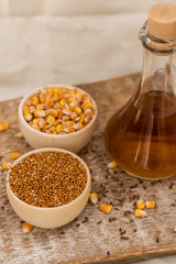 Corn and millet grain in wooden bowls and oil