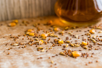 Close up various grains scattered on table and oil