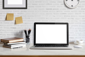 Fototapeta premium Stylish workspace with laptop computer, office supplies gadget at home or studio office. Desk space Mock up blank screen for graphic montage.