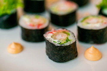 Fresh sushi rolls served on plate in restaurant