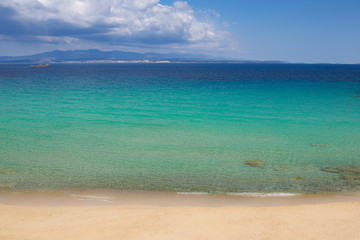 sandy beach and sea, coloured deep blue and turquoise