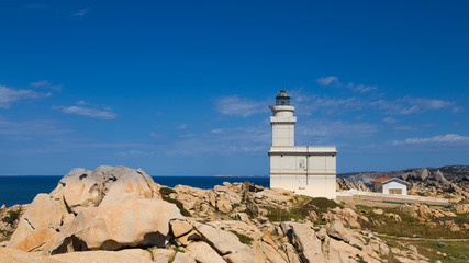 Fototapeta na wymiar coastal scene with blue sky and white lighthouse