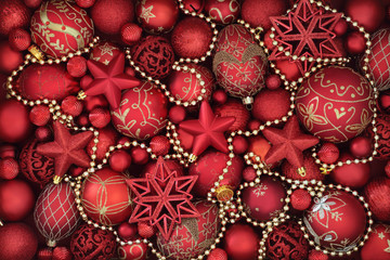Christmas decorative background border with red and gold bauble and bead decorations.